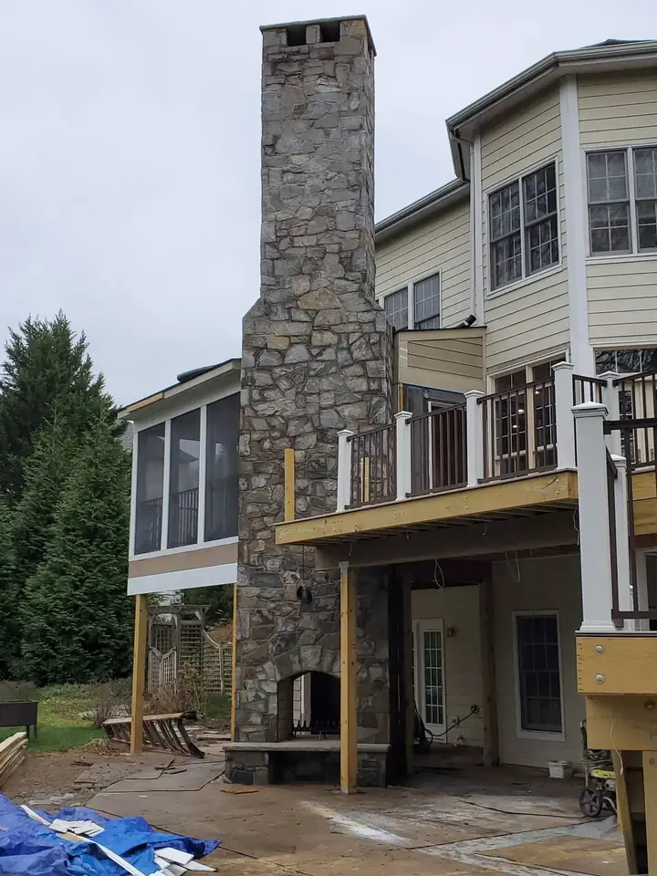 Three-Story Chimney — Potomac, MD · Natural Stone & Arched Firebox
