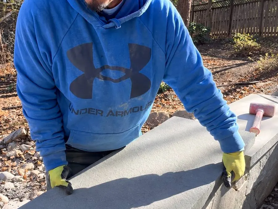 Mason setting a bluestone cap